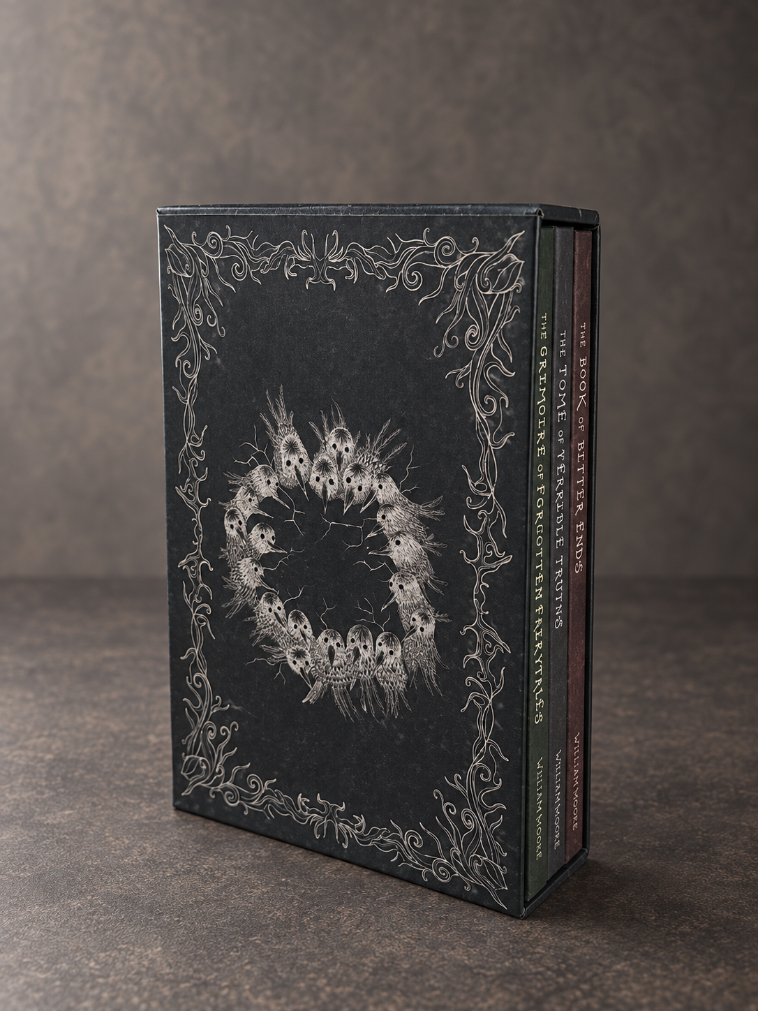 The trilogy in its illustrated slipcase, showing the bird artwork